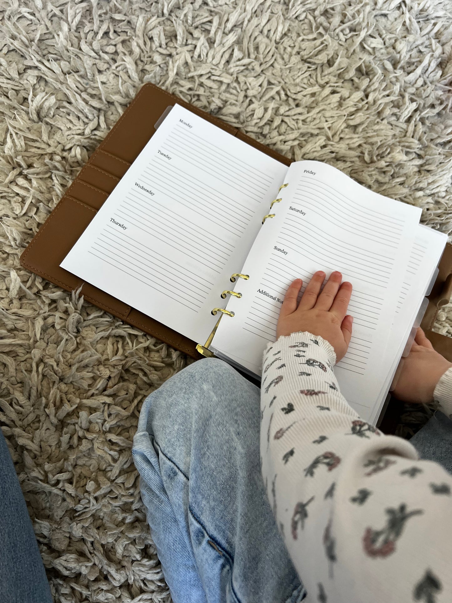 Little girl playing with a parent organiser 