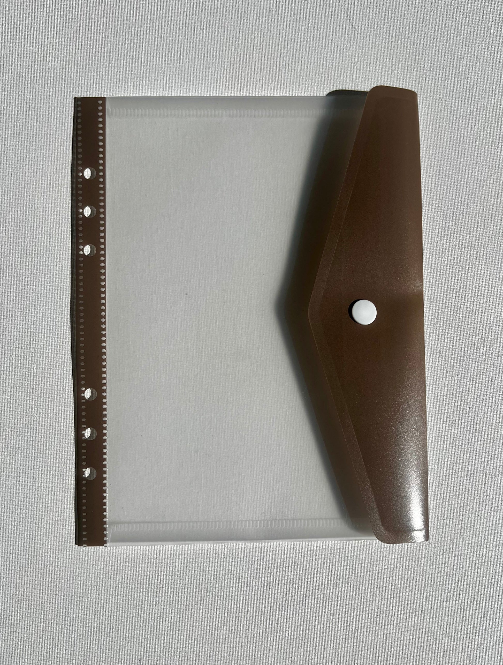 Brown tan leather planner with clear plastic folder with brown clip flap